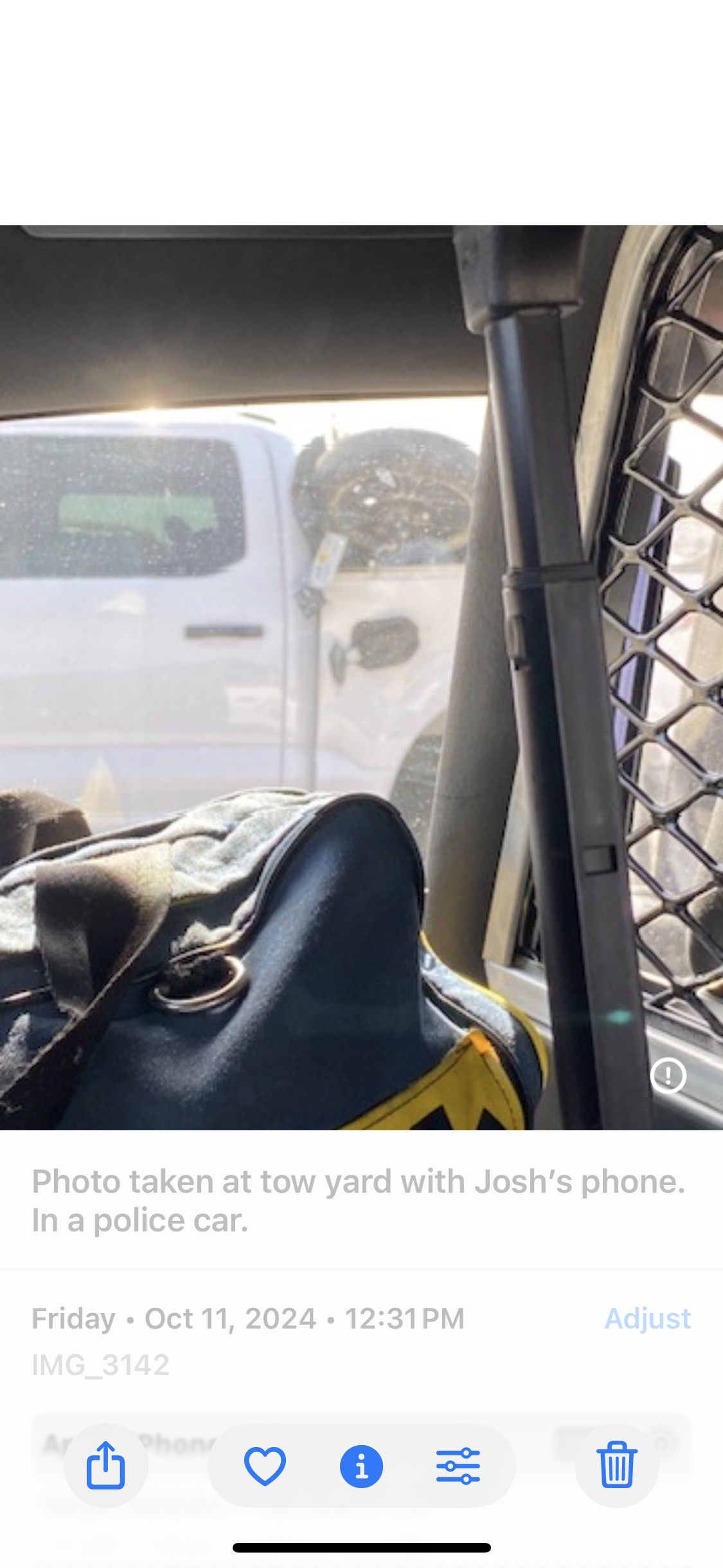 Bag in police cruiser back seat — tow yard — October 11 2024 12:31 PM — Josh