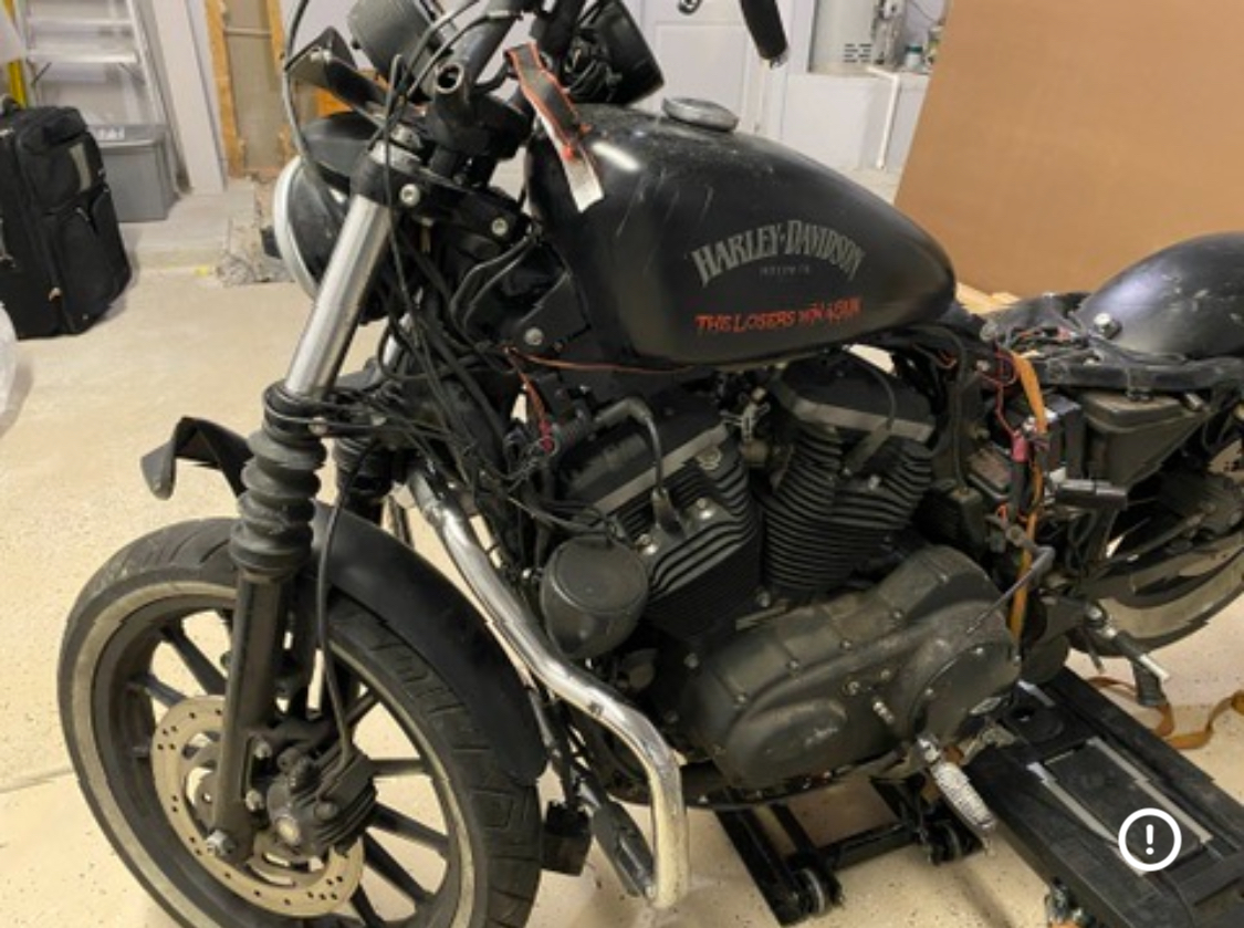 Harley Davidson — bent forks mangled handlebars — post-collision damage