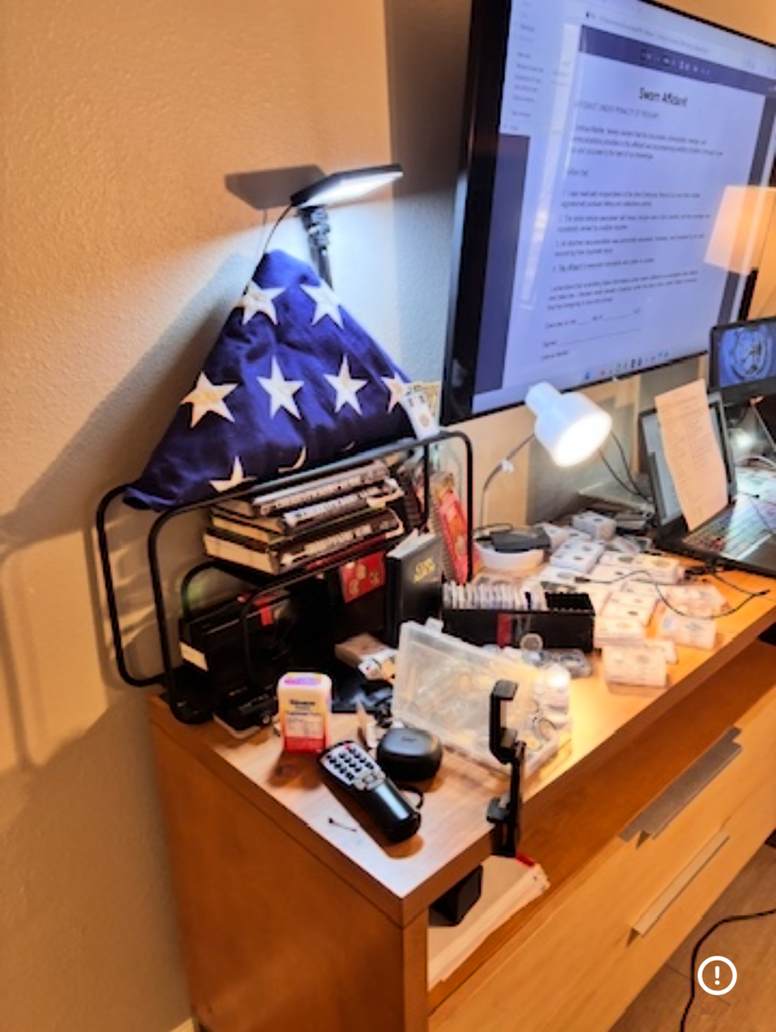 Joshua Markle asleep at workstation — American flag — sworn affidavit on screen